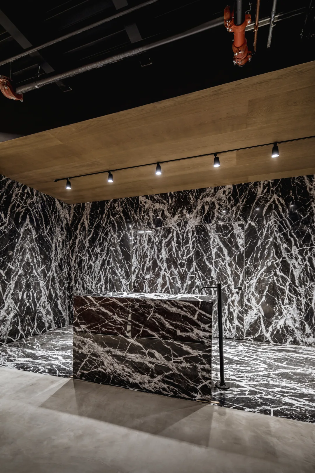 Veined natural stone slab under gallery light at ARCA